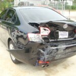 Before and after photographs of a damaged black Volkswagon Jetta that was repaired by Elite Paint & Body Shop in West Palm Beach, Florida.