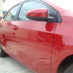 Before and after photographs of a damaged Red Toyota Corolla that was repaired by Elite Paint & Body Shop in West Palm Beach, Florida.