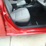 Before and after photographs of a damaged Red Toyota Corolla that was repaired by Elite Paint & Body Shop in West Palm Beach, Florida.