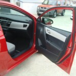 Before and after photographs of a damaged Red Toyota Corolla that was repaired by Elite Paint & Body Shop in West Palm Beach, Florida.
