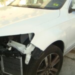 Before and after photographs of a damaged white, AUDI Quattro SUV that was repaired by Elite Paint & Body Shop in West Palm Beach, Florida.