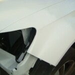 Before and after photographs of a damaged white, AUDI Quattro SUV that was repaired by Elite Paint & Body Shop in West Palm Beach, Florida.