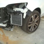 Before and after photographs of a damaged white, AUDI Quattro SUV that was repaired by Elite Paint & Body Shop in West Palm Beach, Florida.