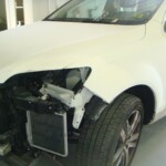 Before and after photographs of a damaged white, AUDI Quattro SUV that was repaired by Elite Paint & Body Shop in West Palm Beach, Florida.