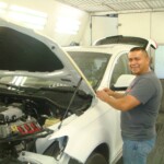 Before and after photographs of a damaged white, AUDI Quattro SUV that was repaired by Elite Paint & Body Shop in West Palm Beach, Florida.