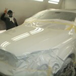 Before and after photographs of a damaged white, AUDI Quattro SUV that was repaired by Elite Paint & Body Shop in West Palm Beach, Florida.