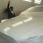 Before and after photographs of a damaged white, AUDI Quattro SUV that was repaired by Elite Paint & Body Shop in West Palm Beach, Florida.