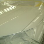 Before and after photographs of a damaged white, AUDI Quattro that was repaired by Elite Paint & Body Shop in West Palm Beach, Florida.